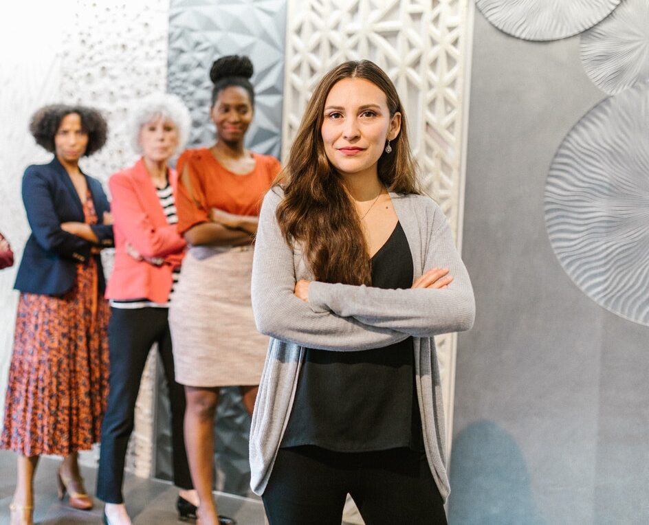 A Group of Women Standing by Pillars