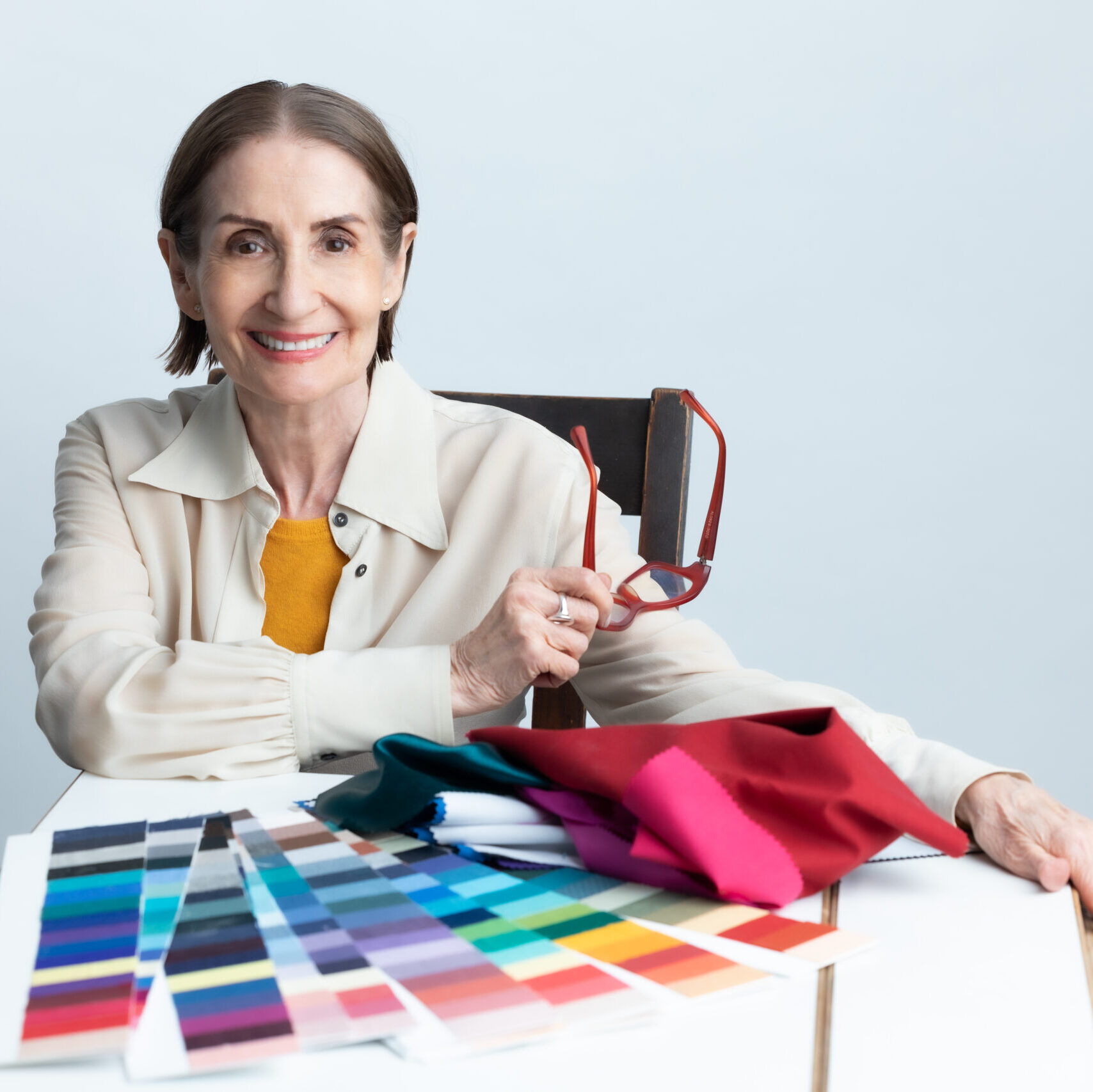 A Woman in a Cream Blouse With Color Cards