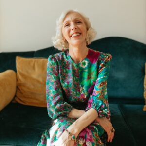 A Blond Woman Smiling in a Floral Dress